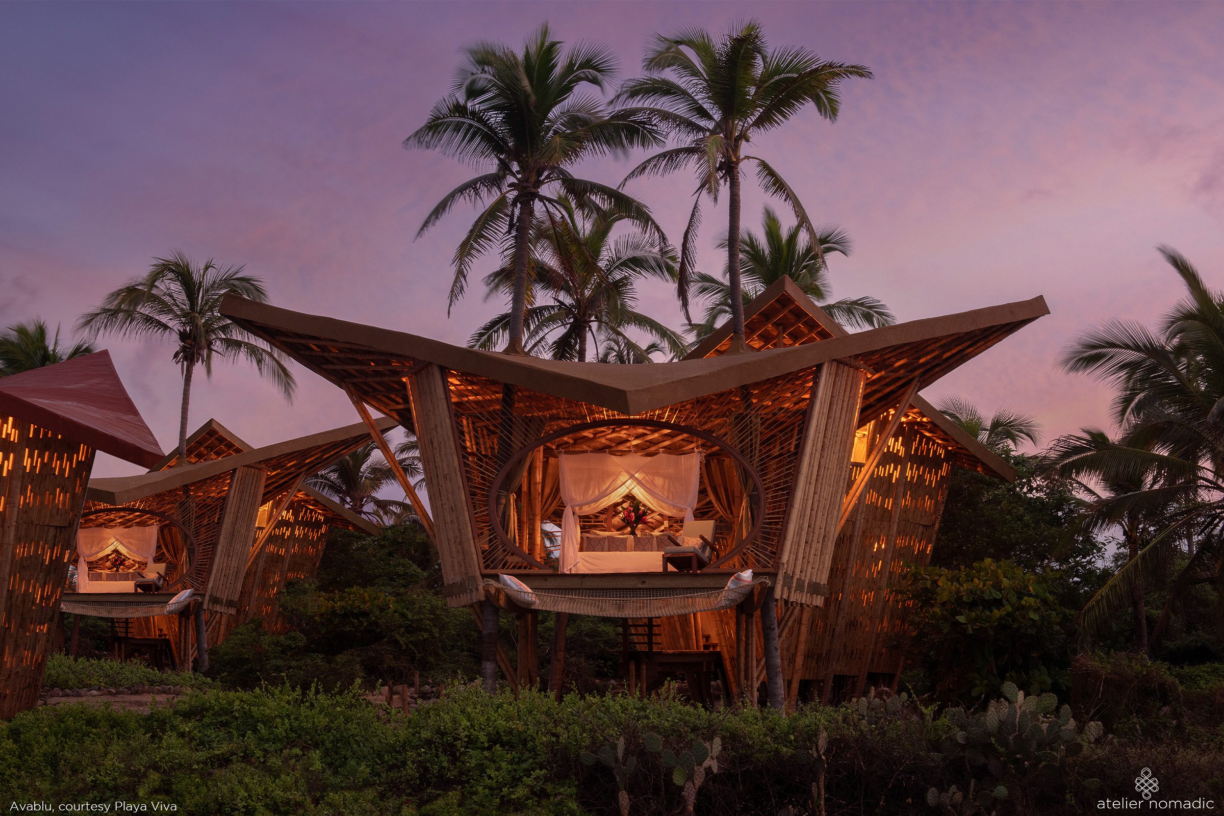The treehouse at the front includes the master bedroom with a hammock net balcony suspended out towards the sea while the annex treehouse at the rear contains the bathroom downstairs and a second bedroom/lounge upstairs, outfitted with daybeds and a desk area.